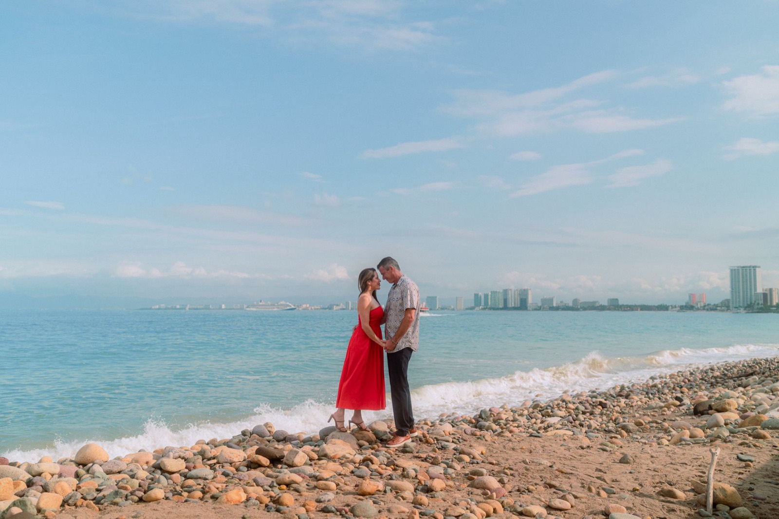 Couple beach photoshoot with Puerto Vallarta skyline at golden hour