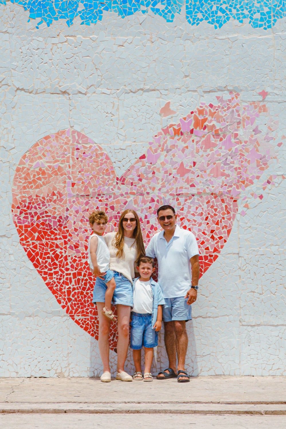Family of four vacation photoshoot at the heart mosaic mural in Puerto Vallarta